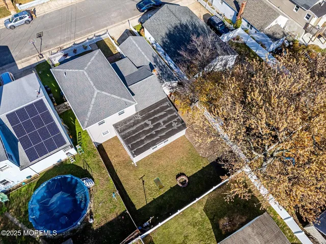 an aerial view of a house with a swimming pool
