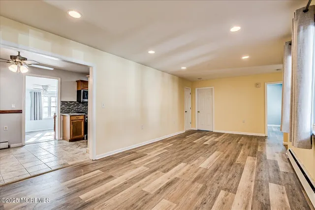 a view of a kitchen with wooden floor and a kitchen