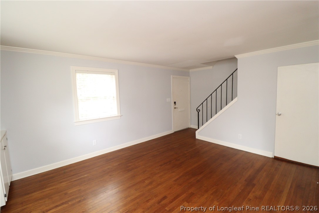 1000 Nichols Drive Raleigh, NC 27605 - Photo 4 of 22 a view of an empty room with wooden floor and fan