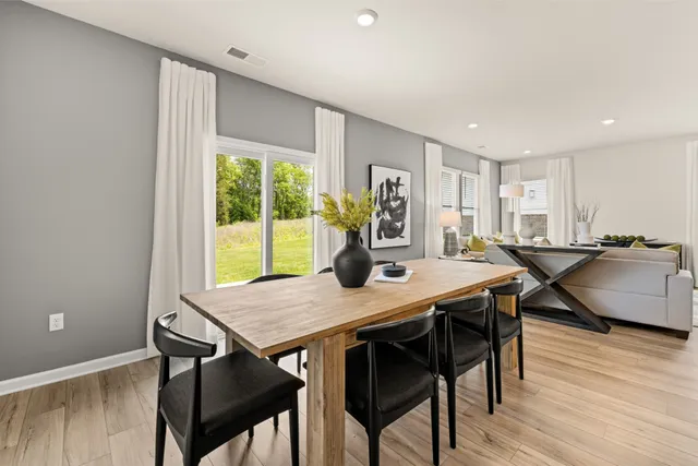 a room with stainless steel appliances kitchen island granite countertop a stove and a sink