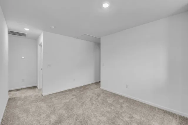 an empty room with a empty space and windows