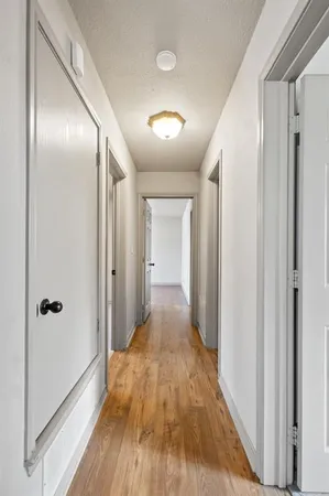 a view of hallway with wooden floor