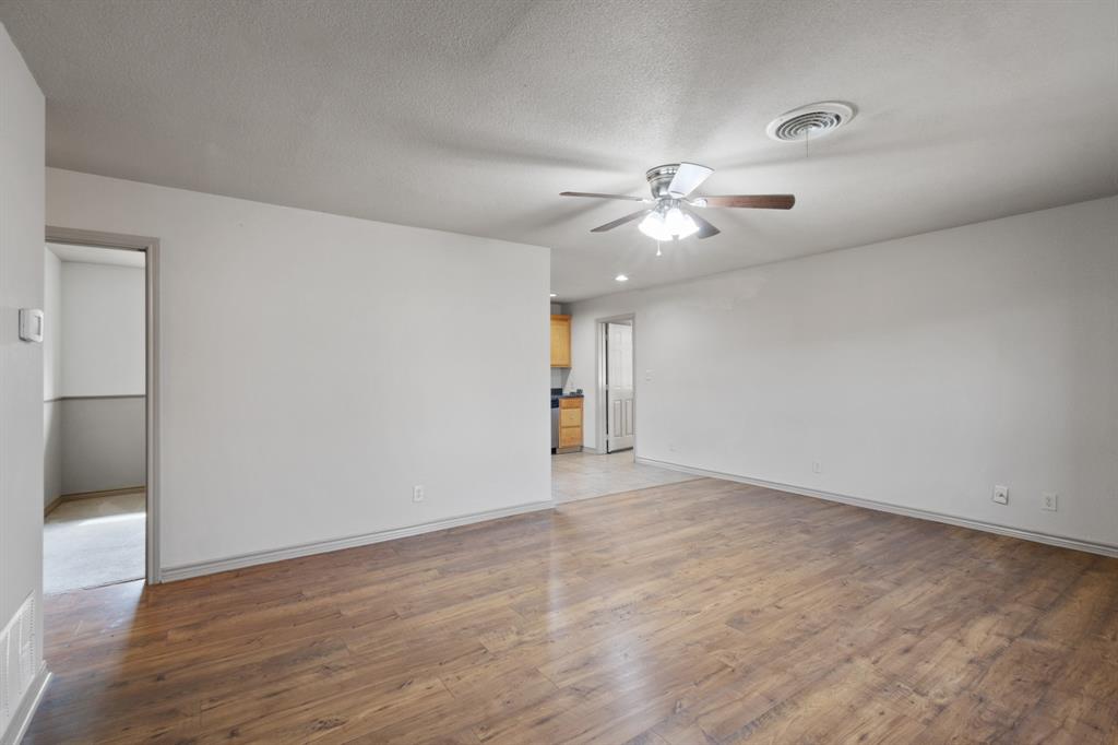 1004 North Cates Street Decatur, TX 76234 - Photo 2 of 30 a view of an empty room with a ceiling fan and window