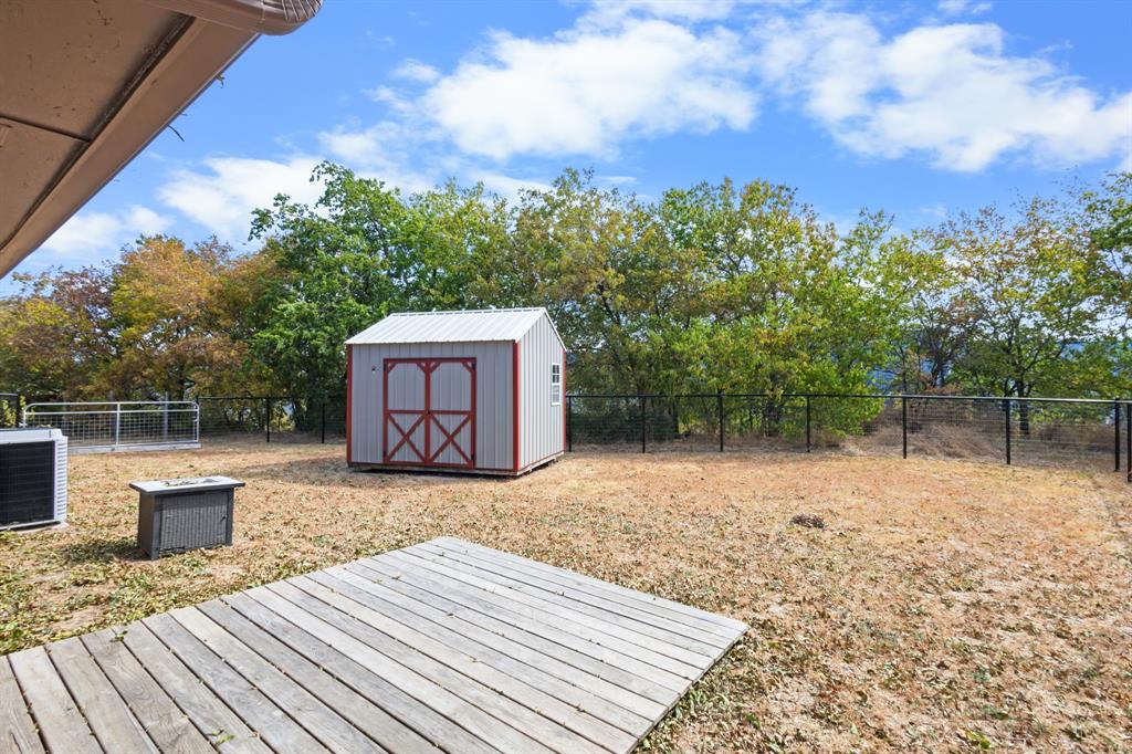 1004 North Cates Street Decatur, TX 76234 - Photo 29 of 30 a backyard of a house with lots of green space
