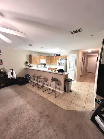 a living room with furniture a flat screen tv and a table