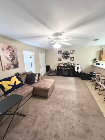 a living room with furniture and a chandelier