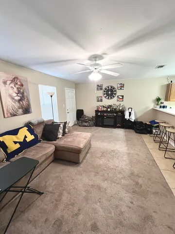 a living room with furniture and a chandelier
