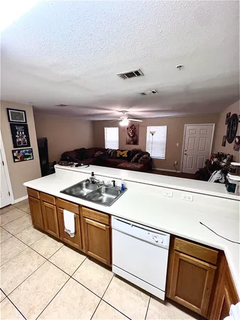 a kitchen with stainless steel appliances a stove a microwave and white cabinets