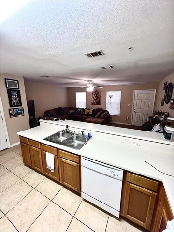 a kitchen with stainless steel appliances a stove a microwave and white cabinets