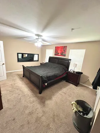 a bedroom with furniture and a air conditioner