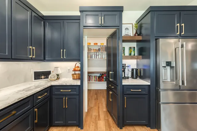 a kitchen with granite countertop stainless steel appliances and wooden cabinets
