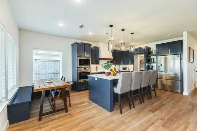 a dining room with furniture and wooden floor