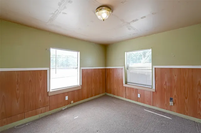 an empty room with windows and closet