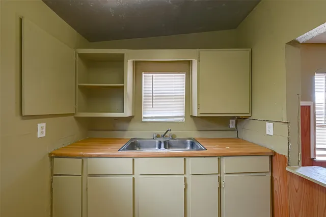 a view of hallway with a bathroom