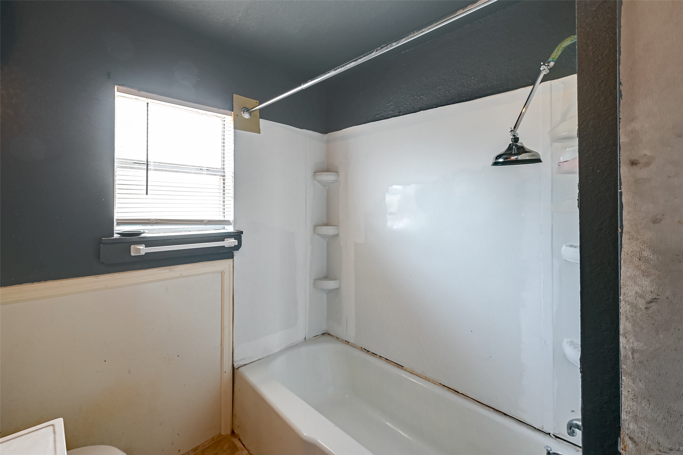 803 Mattie Street Wharton, TX 77488 - Photo 25 of 31 a bathroom with a bathtub and a window