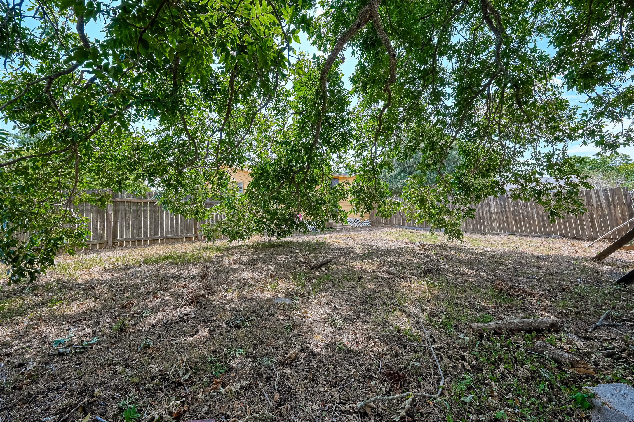 803 Mattie Street Wharton, TX 77488 - Photo 29 of 31 a view of a backyard with large trees and wooden fence