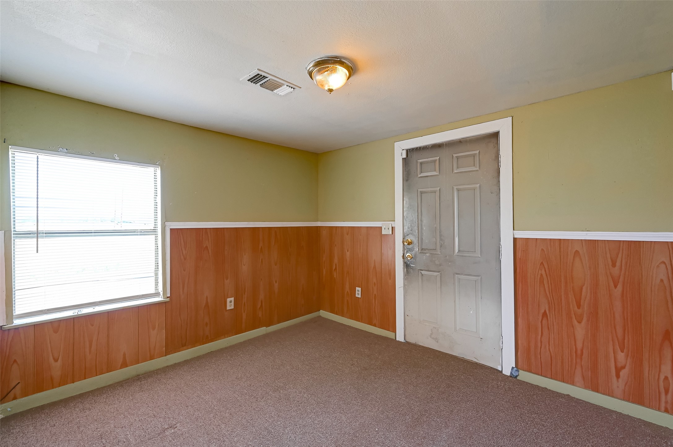 803 Mattie Street Wharton, TX 77488 - Photo 10 of 31 an empty room with windows & cabinet