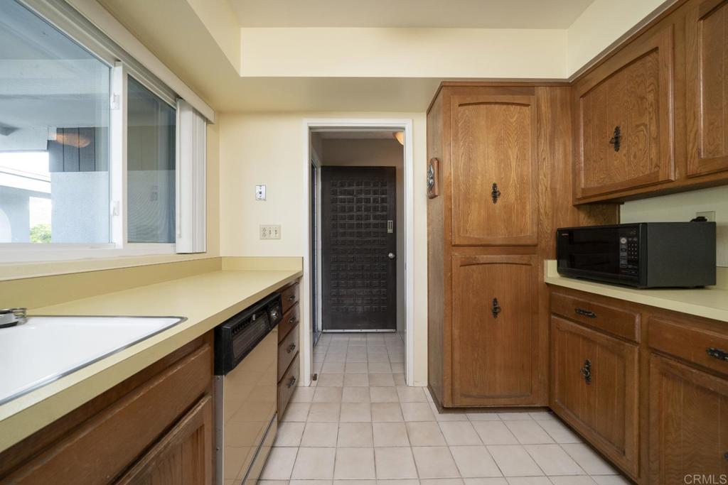 3606 Vista Rey, Unit 46 Oceanside, CA 92057 - Photo 11 of 32 a kitchen with a refrigerator and cabinets