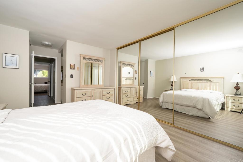 3606 Vista Rey, Unit 46 Oceanside, CA 92057 - Photo 21 of 32 a bedroom with a bed and a large mirror