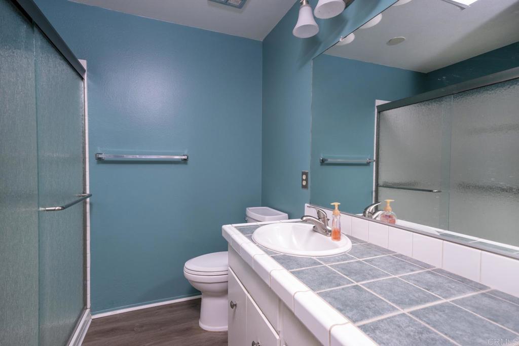 3606 Vista Rey, Unit 46 Oceanside, CA 92057 - Photo 23 of 32 a bathroom with a sink and a toilet