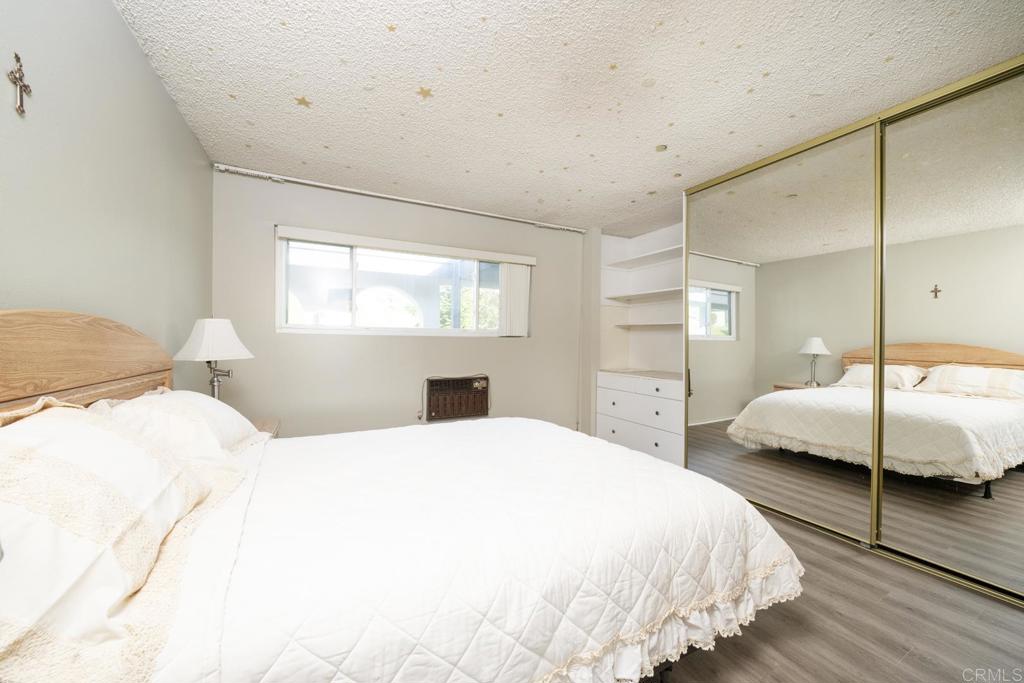 3606 Vista Rey, Unit 46 Oceanside, CA 92057 - Photo 26 of 32 a bedroom with a bed and a large window