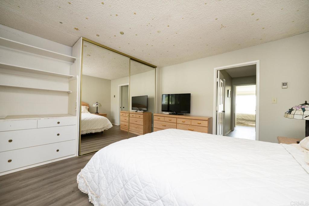 3606 Vista Rey, Unit 46 Oceanside, CA 92057 - Photo 27 of 32 a bedroom with a bed and a flat tv screen