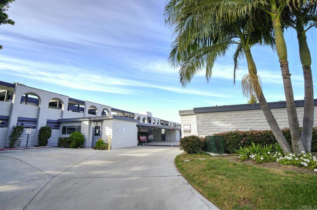 3606 Vista Rey, Unit 46 Oceanside, CA 92057 - Photo 30 of 32 a front view of a house with a yard and garage