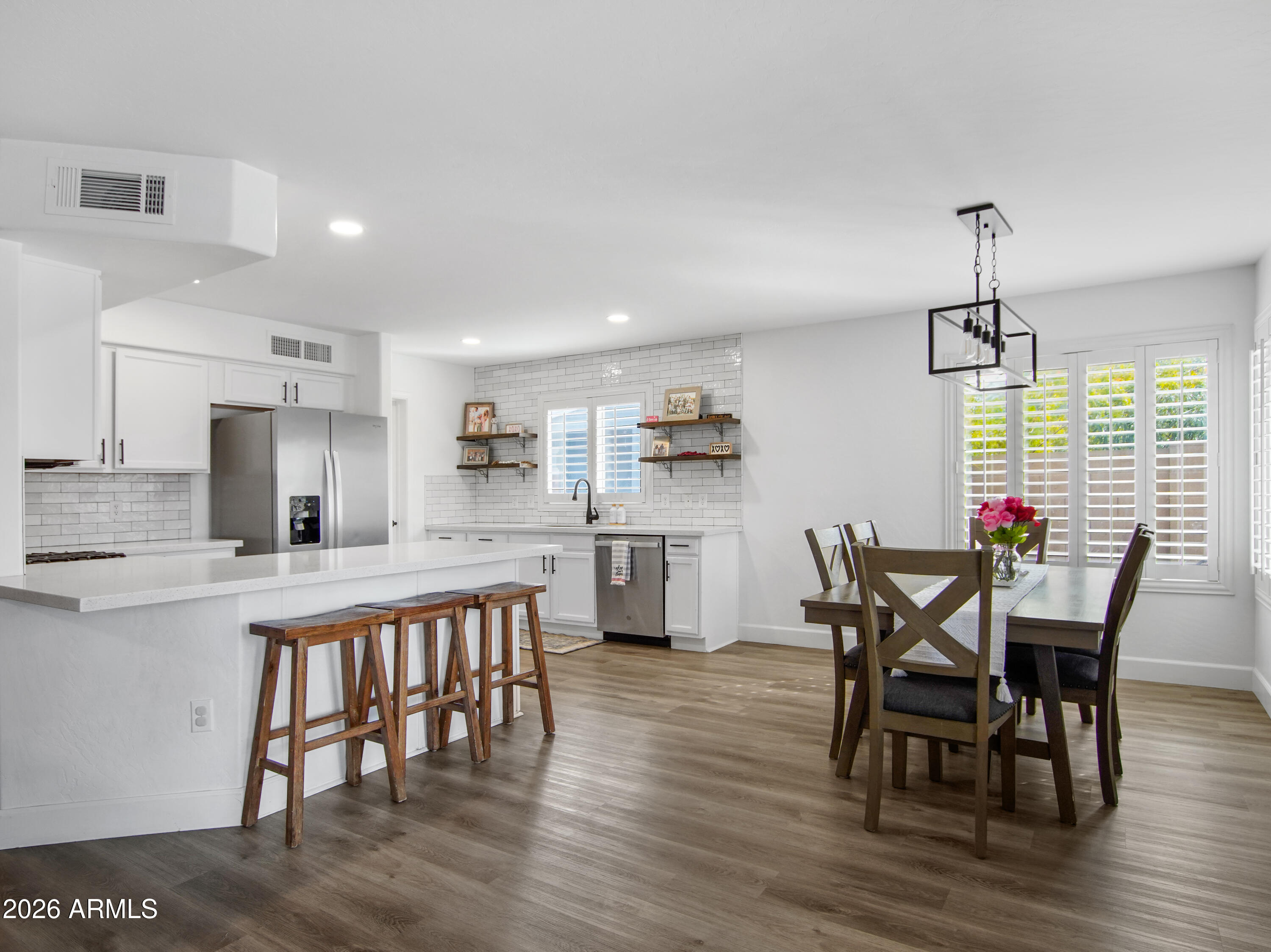 1960 South Portland Court Gilbert, AZ 85295 - Photo 15 of 53 a view of a dining room with furniture and wooden floor