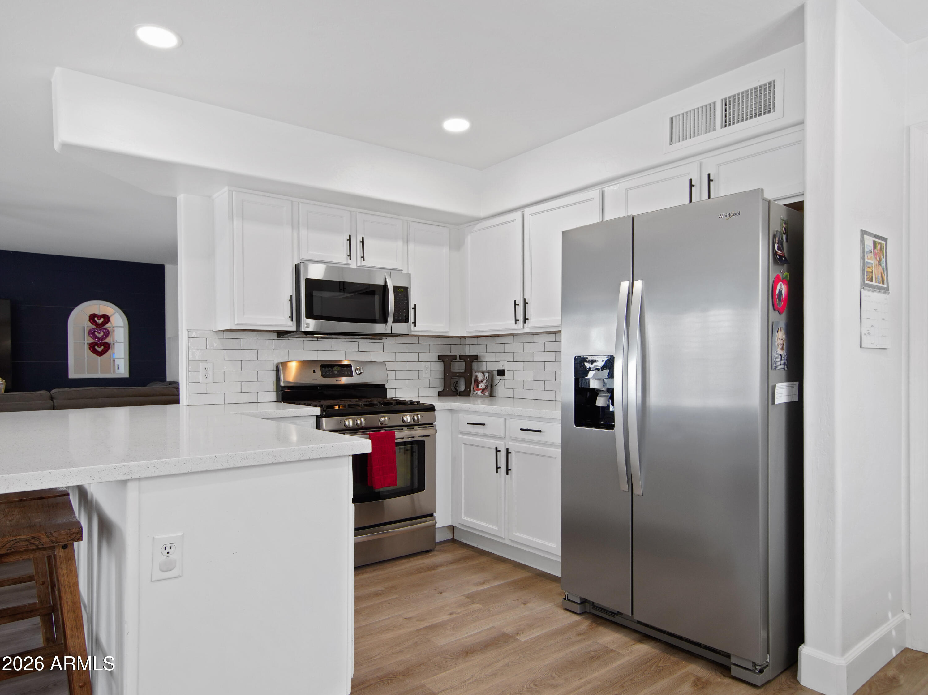 1960 South Portland Court Gilbert, AZ 85295 - Photo 18 of 53 a kitchen with stainless steel appliances granite countertop a refrigerator stove microwave and sink
