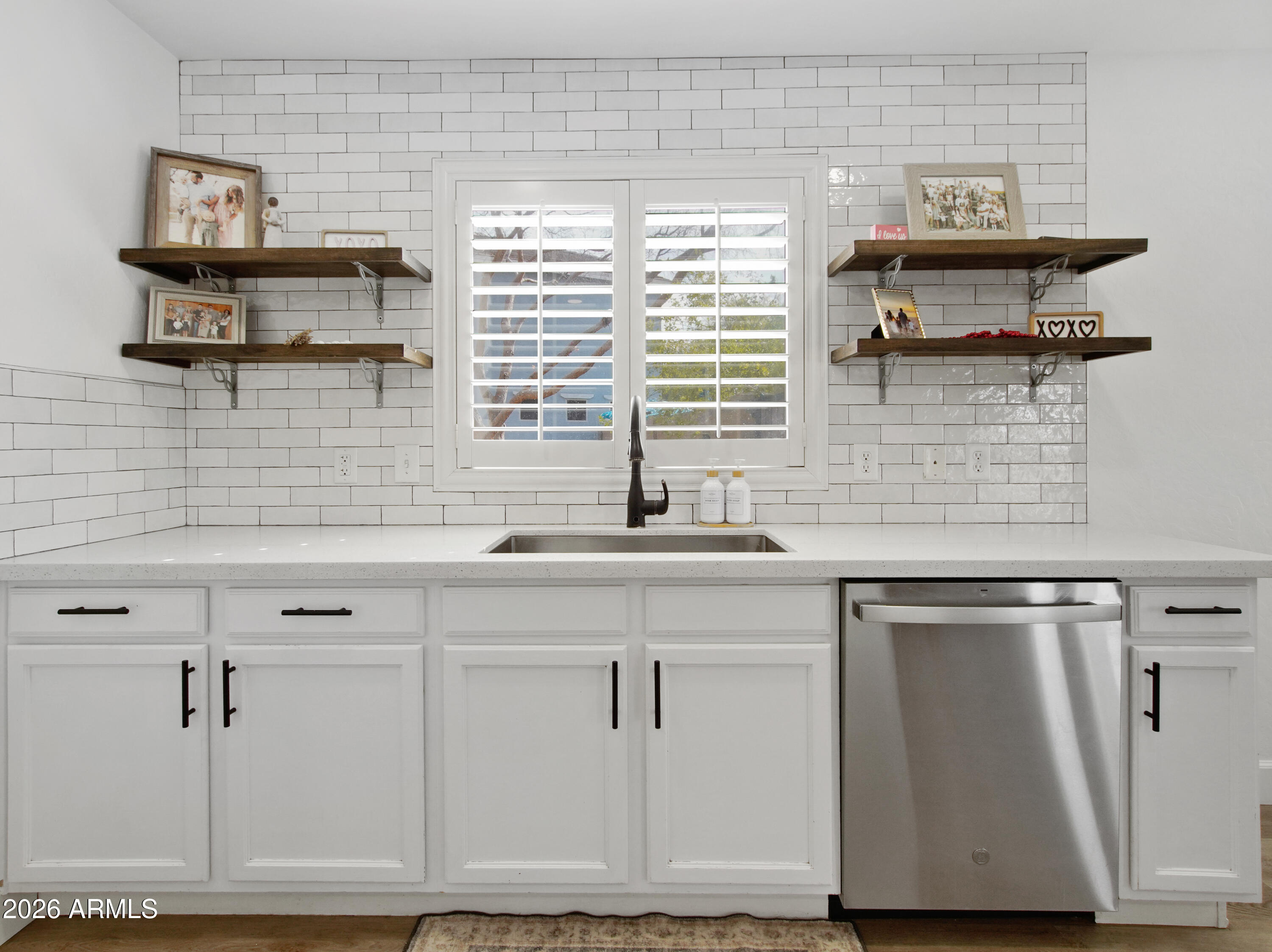 1960 South Portland Court Gilbert, AZ 85295 - Photo 21 of 53 a kitchen with stainless steel appliances a sink and cabinets