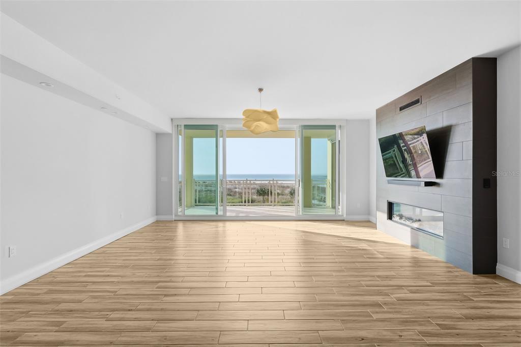 800 Collany Road, Unit 302 St. Petersburg, FL 33715 - Photo 19 of 66 a view of an empty room with a window and wooden floor