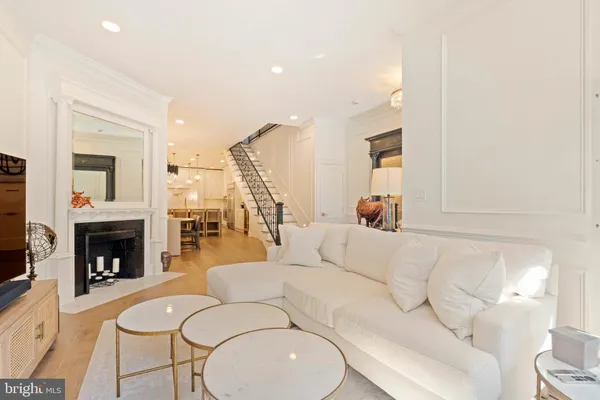 a kitchen with kitchen island a counter top a fireplace and a chandelier