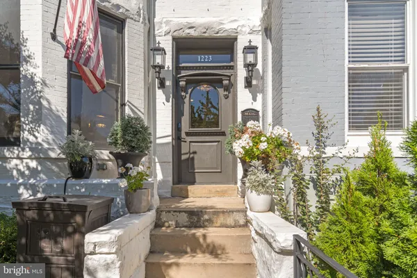 a view of a house with potted plants