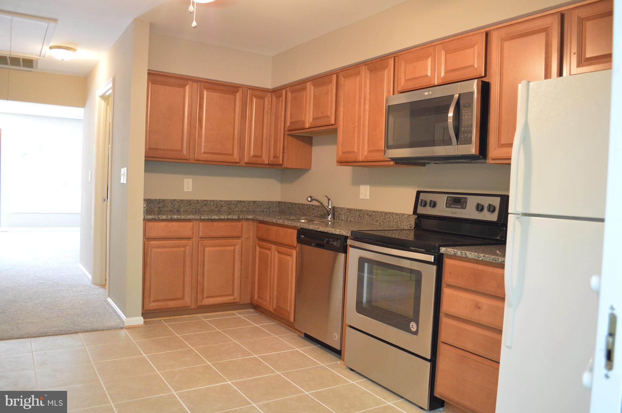 934 Riversedge Circle Annapolis, MD 21401 - Photo 16 of 25 a kitchen with stainless steel appliances granite countertop a refrigerator stove top oven and sink