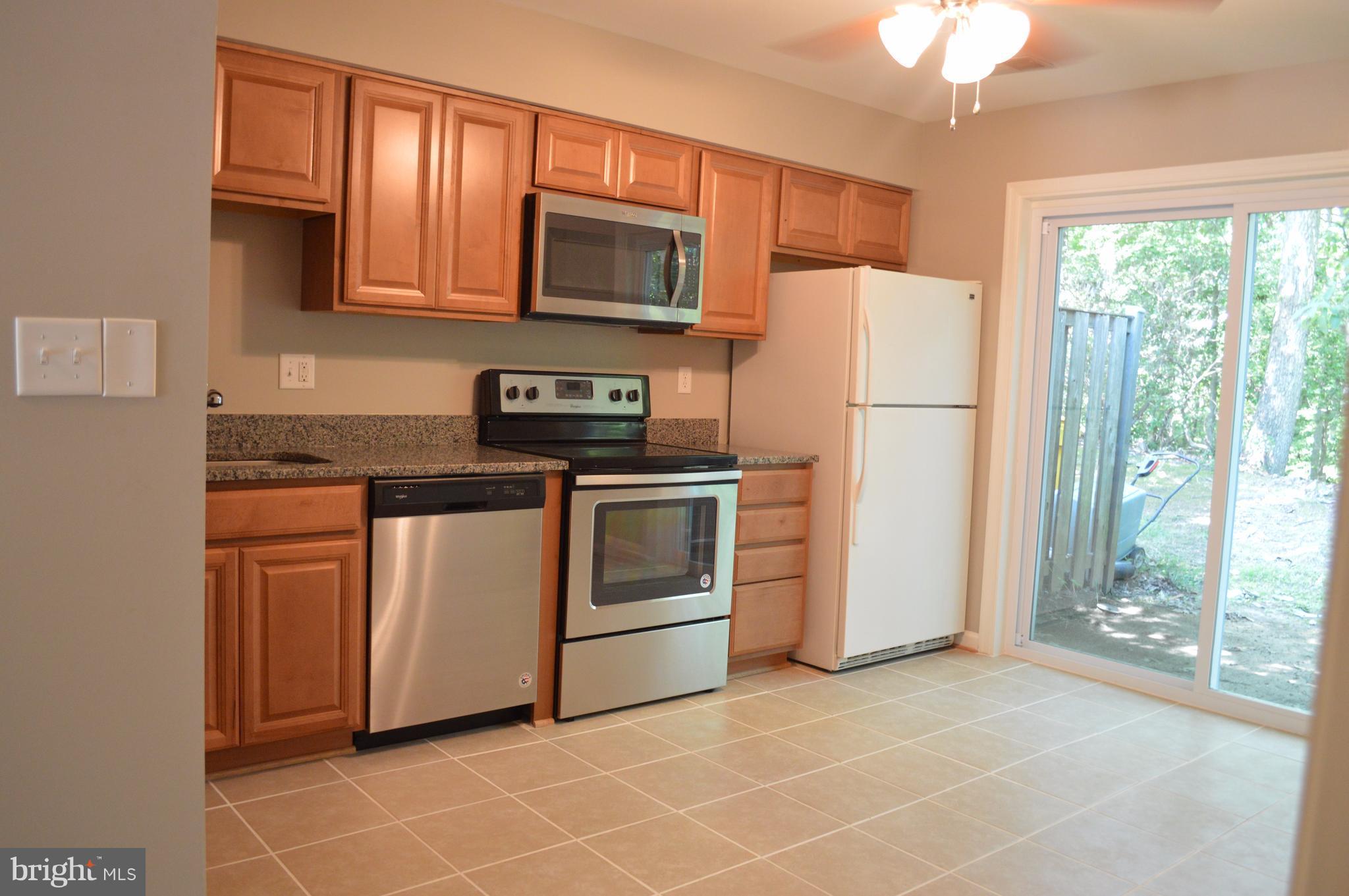 934 Riversedge Circle Annapolis, MD 21401 - Photo 18 of 25 a kitchen with white cabinets stainless steel appliances and window