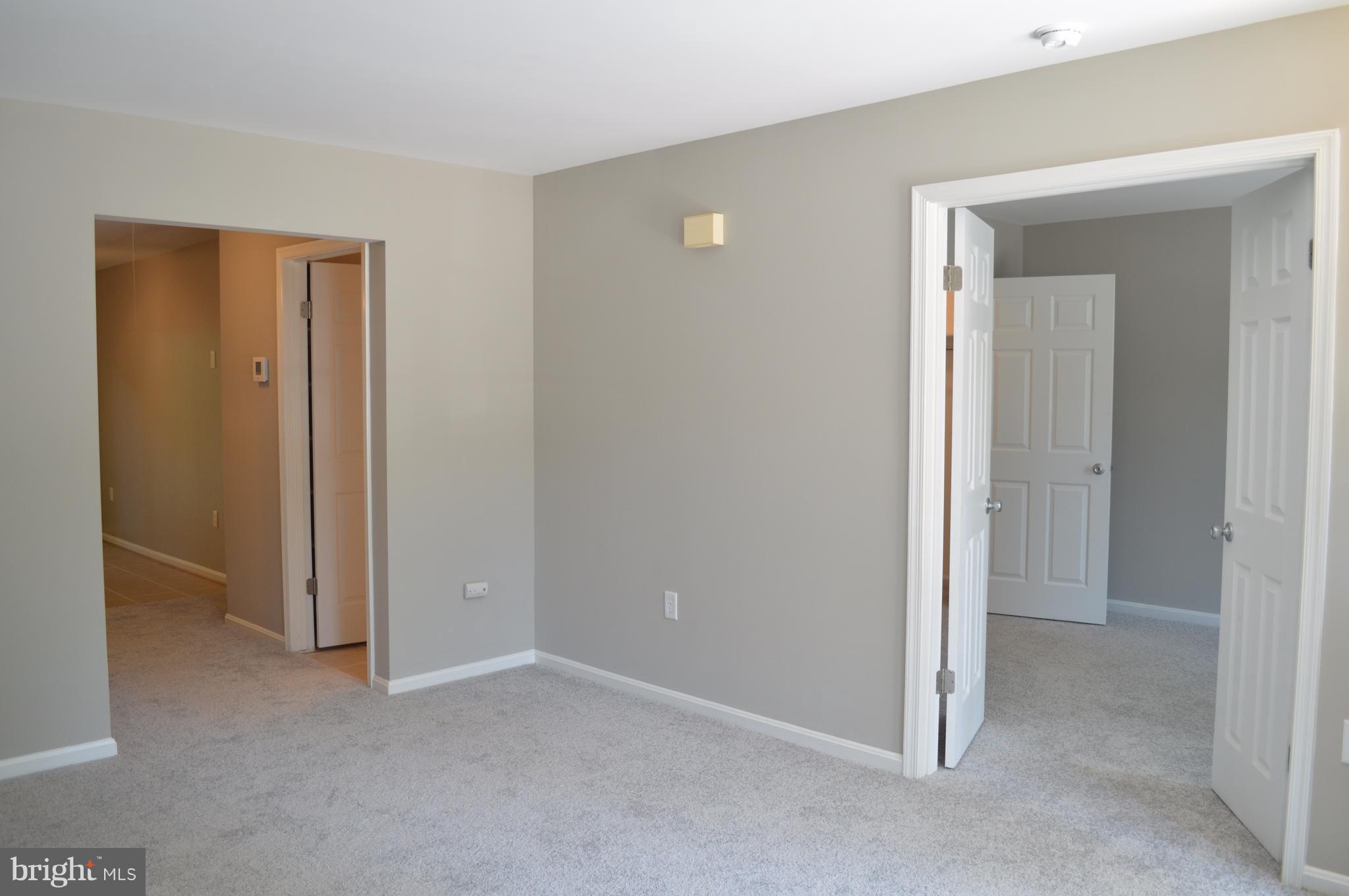 934 Riversedge Circle Annapolis, MD 21401 - Photo 6 of 25 a view of an empty room with closet and wooden door