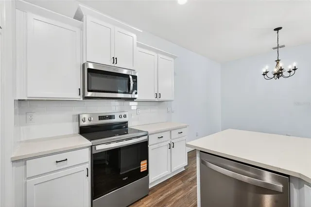 a kitchen with a stove and a microwave