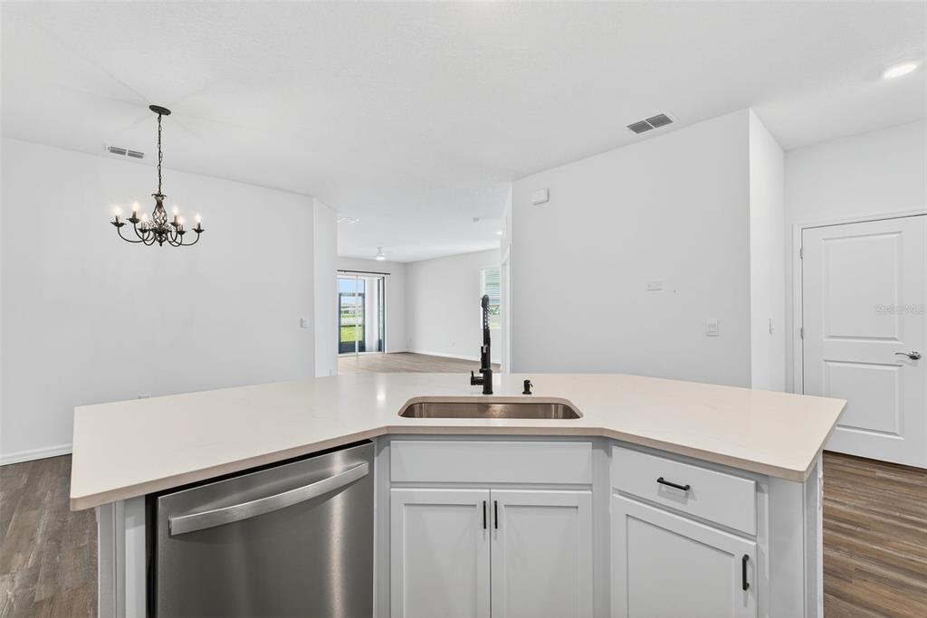 31463 Paper Birch Street Wesley Chapel, FL 33545 - Photo 13 of 40 a kitchen with a sink and a refrigerator