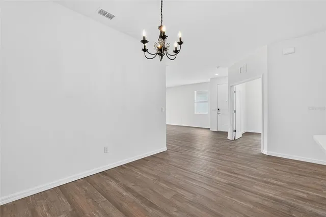 an empty room with wooden floor and sliding door