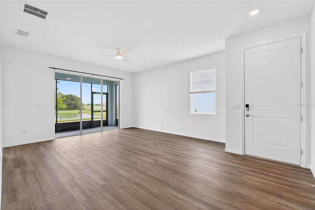 31463 Paper Birch Street Wesley Chapel, FL 33545 - Photo 19 of 40 a view of an empty room with wooden floor and a window