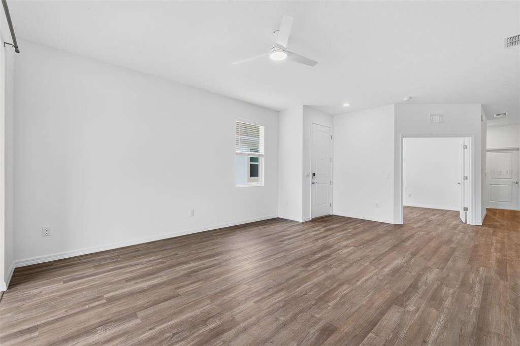 31463 Paper Birch Street Wesley Chapel, FL 33545 - Photo 20 of 40 a view of empty room with wooden floor and window