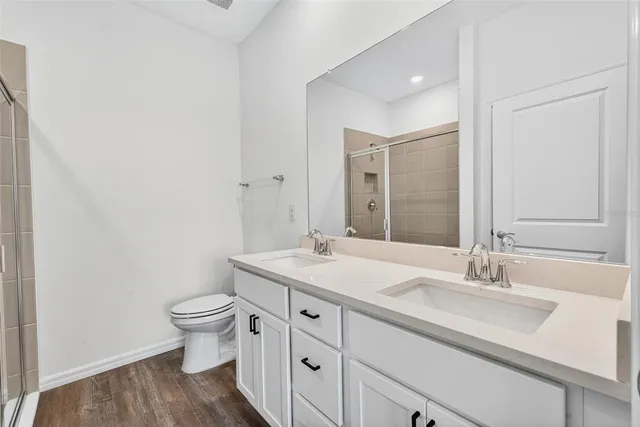a bathroom with a glass shower door