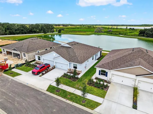 an aerial view of a house with a yard