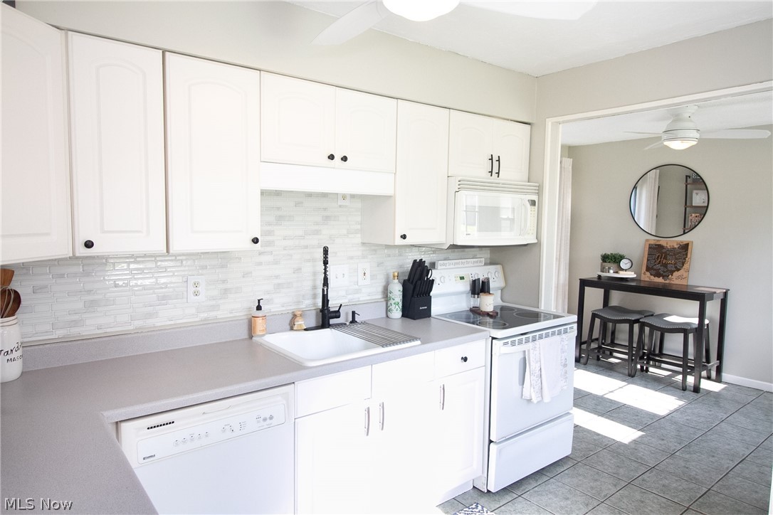4796 Forest Road Mentor, OH 44060 - Photo 8 of 34 Kitchen featuring white appliances, light tile flooring, white cabinetry, sink, and ceiling fan