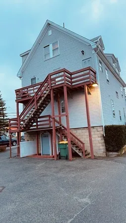 a view of a house with a car parked in garage