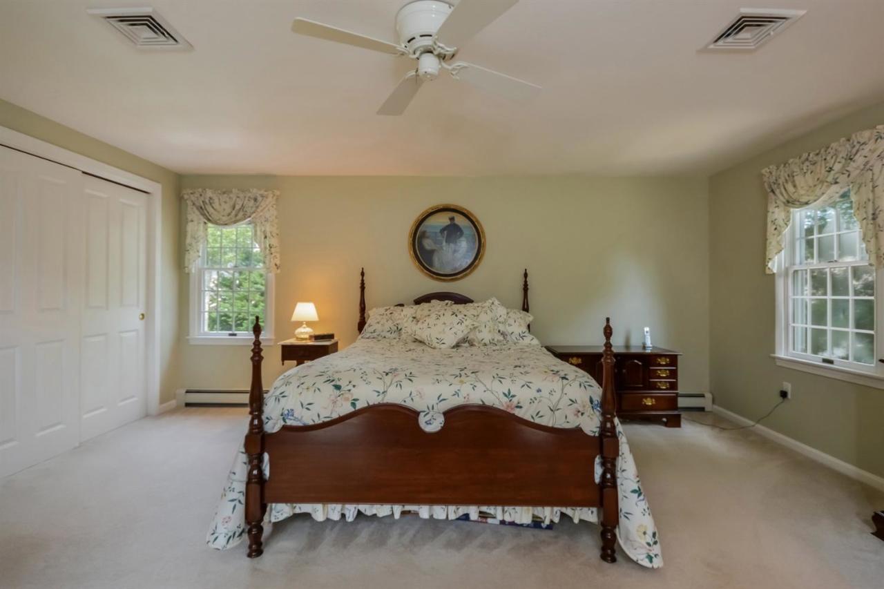 164 Scudder Road Osterville, MA 02655 - Photo 12 of 30 a bed sitting in a bedroom next to a window
