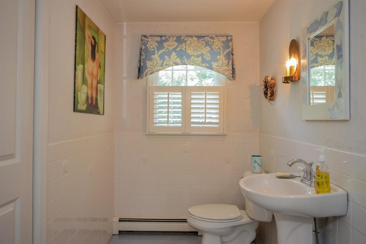 164 Scudder Road Osterville, MA 02655 - Photo 15 of 30 a bathroom with a toilet sink and mirror