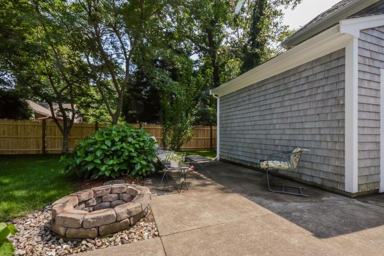 164 Scudder Road Osterville, MA 02655 - Photo 21 of 30 a view of a backyard with plants and a tree