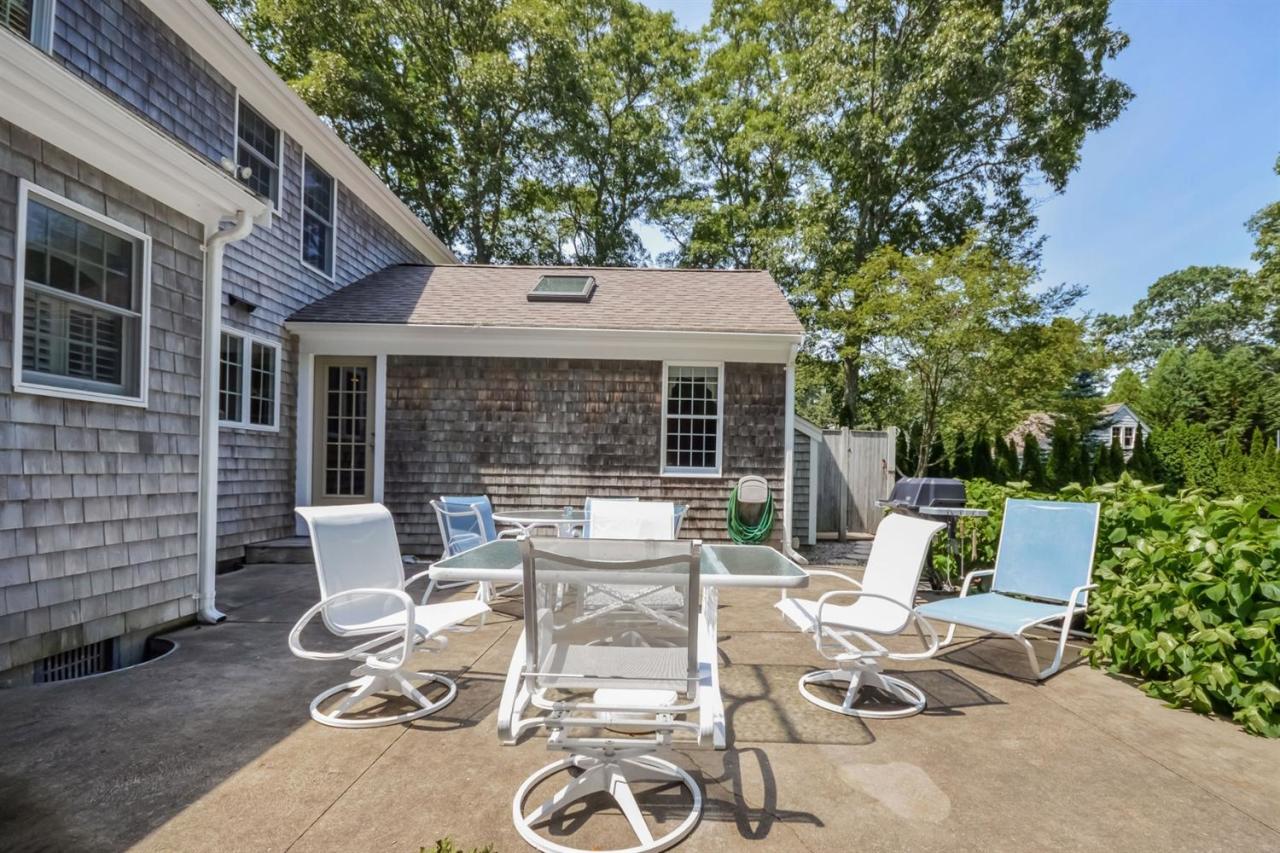 164 Scudder Road Osterville, MA 02655 - Photo 22 of 30 a view of a patio with table and chairs and potted plants