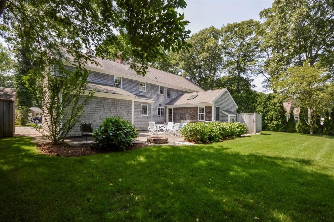 164 Scudder Road Osterville, MA 02655 - Photo 23 of 30 a front view of a house with a yard and garage